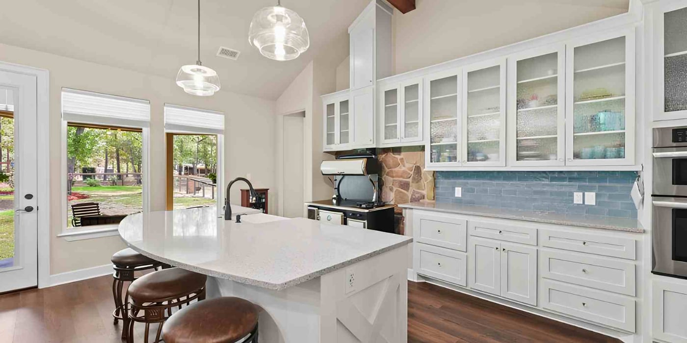 Image of a kitchen with custom cabinetry and an on-island sink in a custom home by Wonderview Custom Homes