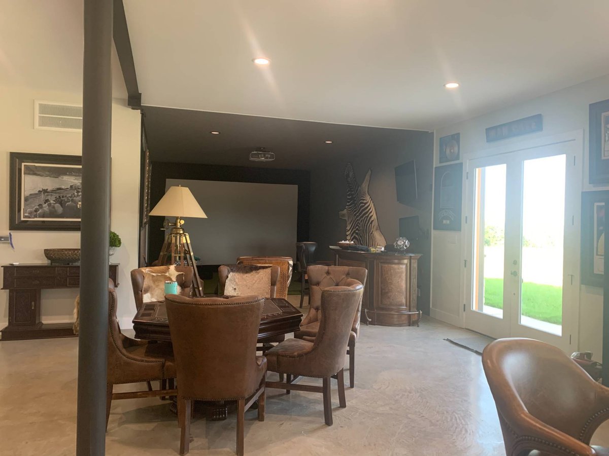 Rustic entertainment room inside a Wonderview Home Services residential barndominium in Navasota, TX with leather seating and ho-optimized