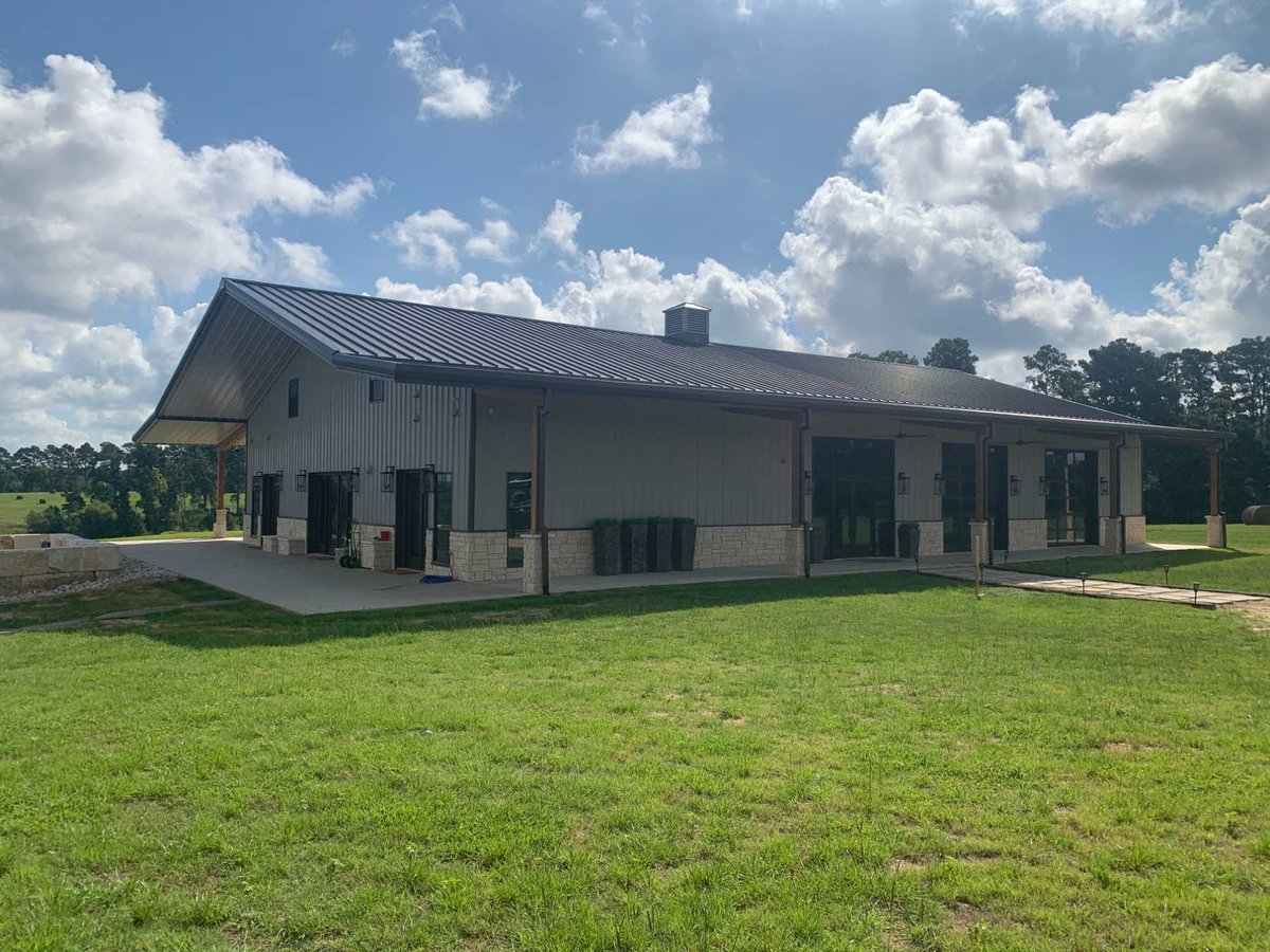 Large commercial building exterior with metal roofing by Wonderview Home Services in Navasota, TX.-optimized