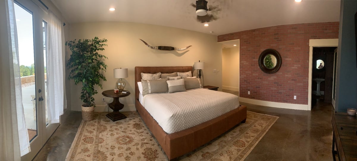 Rustic commercial bedroom with brick accent wall and modern decor by Wonderview Home Services in Navasota, TX.-optimized