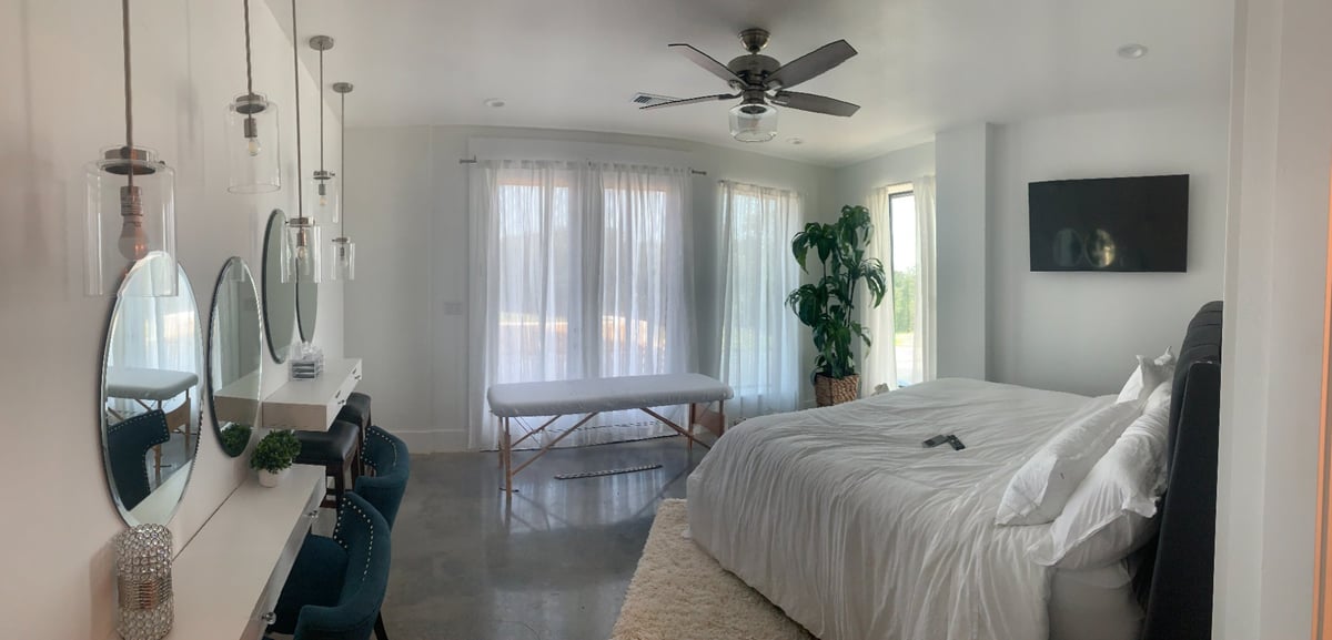 Spacious commercial bedroom suite with modern lighting and large windows by Wonderview Home Services in Navasota, TX.-optimized