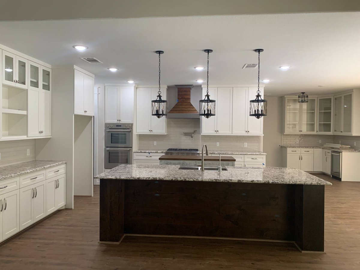 Residential new construction kitchen by Wonderview Home Services in Magnolia, Texas with white cabinetry and pendant lighting-optimized