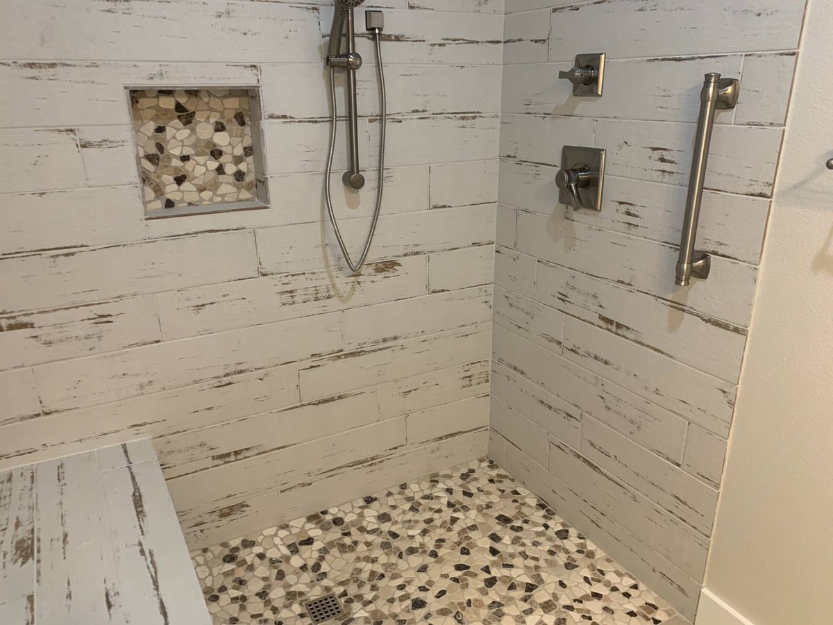 Walk-in tile shower in a Wonderview Home Services residential new construction home in Magnolia, TX.-optimized