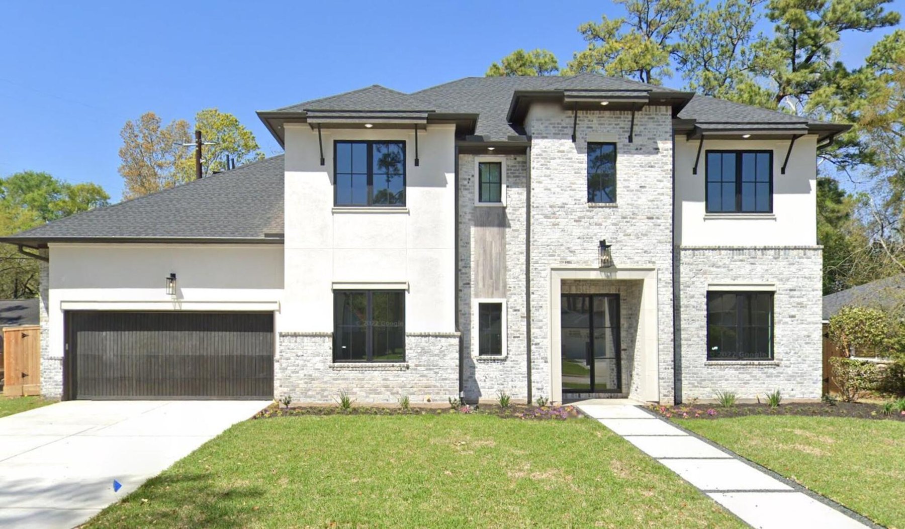 Luxury custom home exterior featuring contemporary architecture and oversized garage in Houston, TX by Wonderview Home Services.-optimized