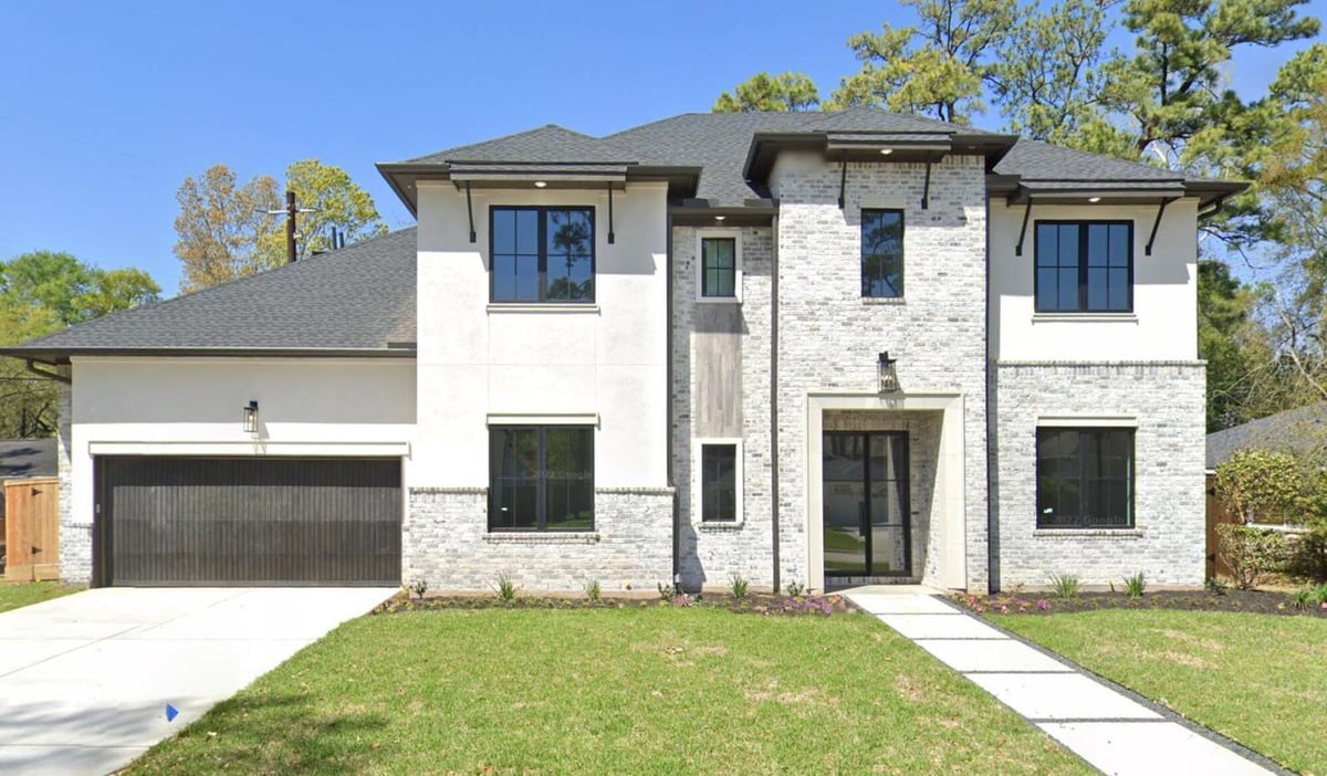 Luxury custom home exterior featuring contemporary architecture and oversized garage in Houston, TX by Wonderview Home Services.-optimized