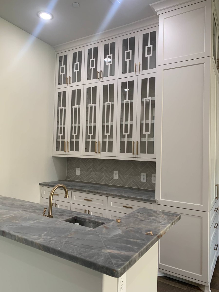 Luxury kitchen detail with tall white cabinets and brass hardware by Wonderview Home Services in Houston, TX.-optimized