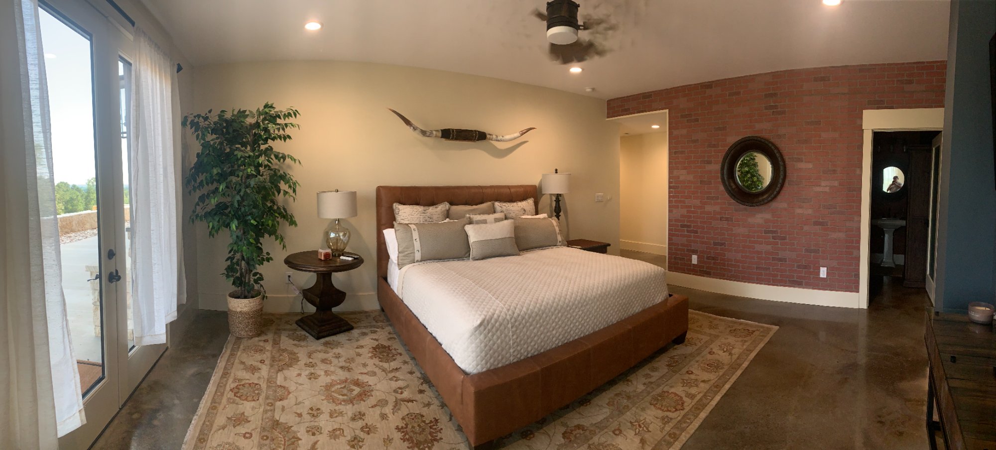 Rustic commercial bedroom with brick accent wall and modern decor by Wonderview Home Services in Navasota, TX.-optimized