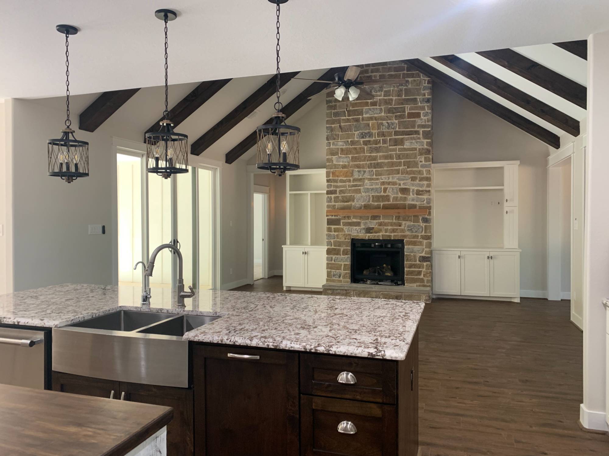 Modern farmhouse kitchen and fireplace design by Wonderview Home Services in Magnolia, TX residential new construction.-optimized