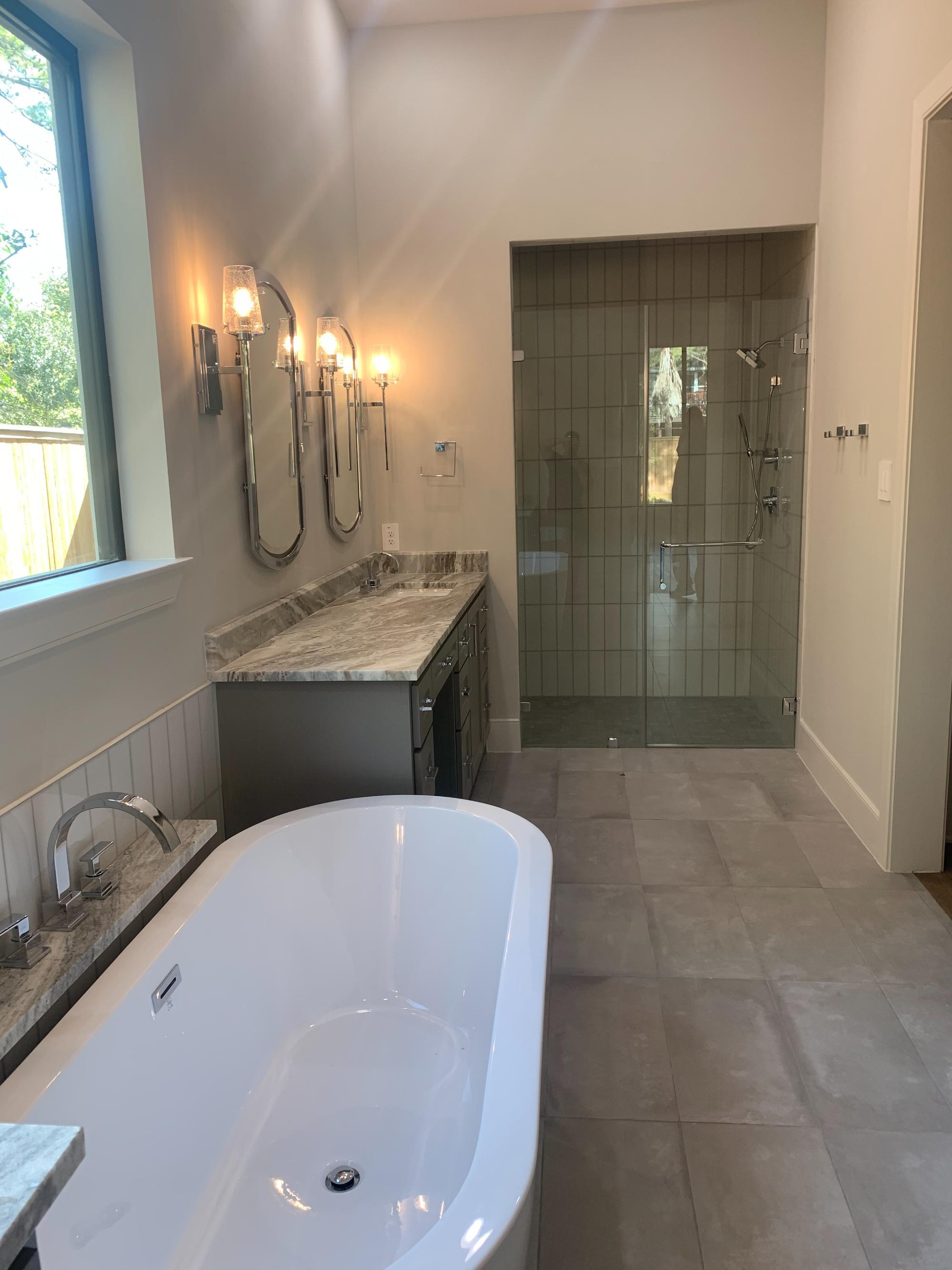 Spa-inspired master bathroom with freestanding tub and walk-in shower by Wonderview Home Services in Houston, TX.-optimized