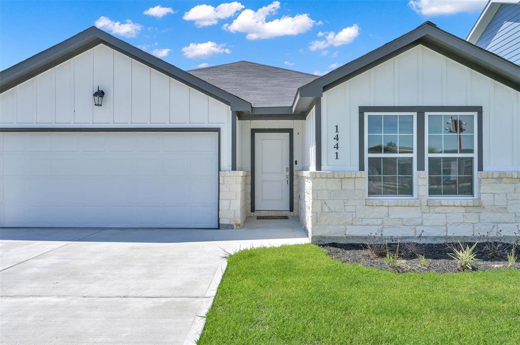 Single-story residential new construction home with stone facade by Wonderview Home Services in Cleveland, TX.-optimized