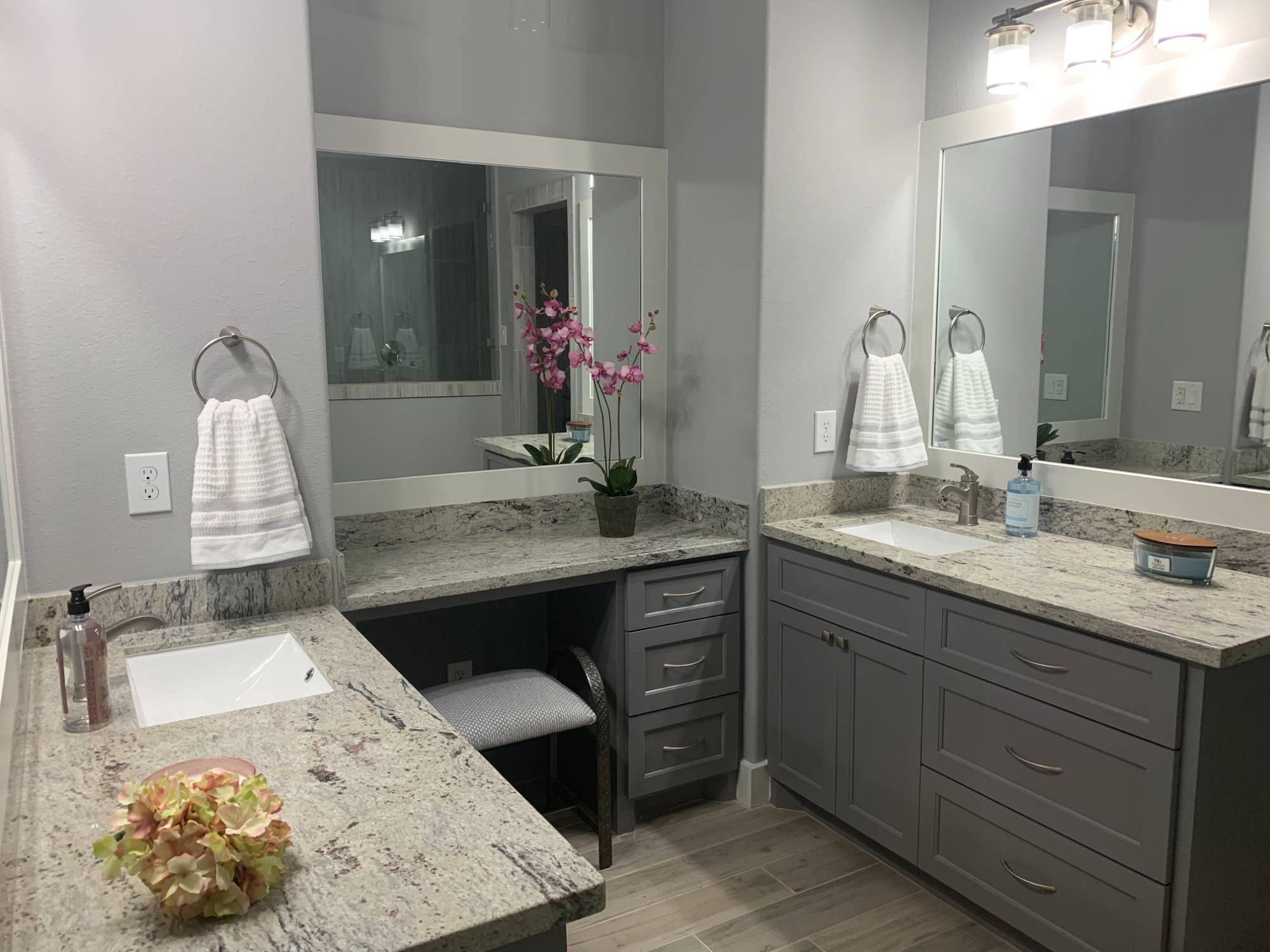 Modern bathroom with dual vanities and granite countertops by Wonderview Home Services in New Waverly, TX.-optimized